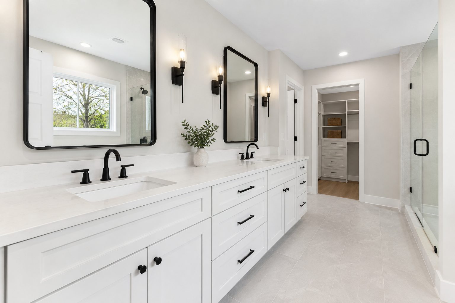 Bathroom remodel with a white double vanity, quartz counter, and matte black fixtures